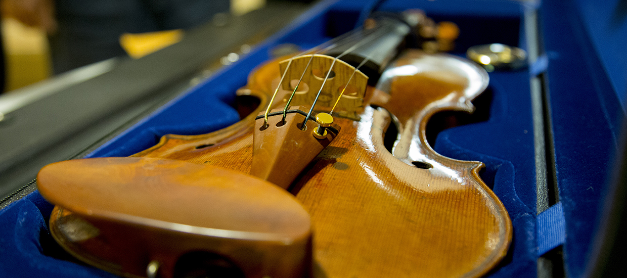 Sue Miller Violin sitting in an open carrying case lined in a blue colored lining